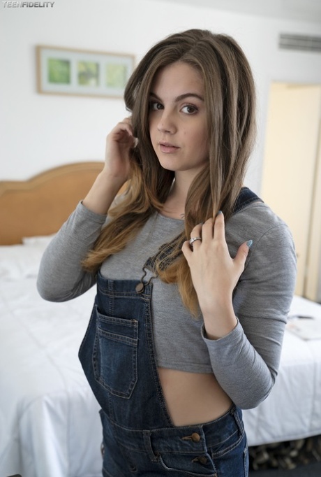 Adorable teen Devon Green pulls off her shorts to show sweet ass on the bed