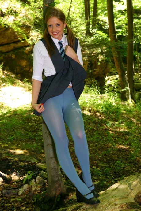 Horny schoolgirl Maddie M stripping to her blue pantyhose in the woods - pornpics.de