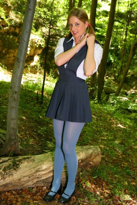 Horny schoolgirl Maddie M stripping to her blue pantyhose in the woods - pornpics.de