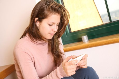 Teen Suzi D sits down on the stairs, nudes her pussy and rubs it with a finger