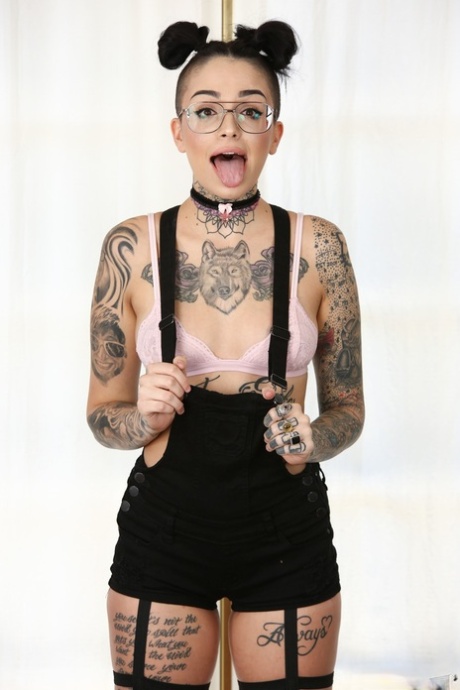 Pigtailed & inked Leigh Raven in sneakers & glasses spreads legs & pussy lips
