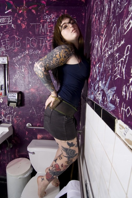 Glasses clad Adahlia does sensual bathroom striptease flaunting tattooed ass