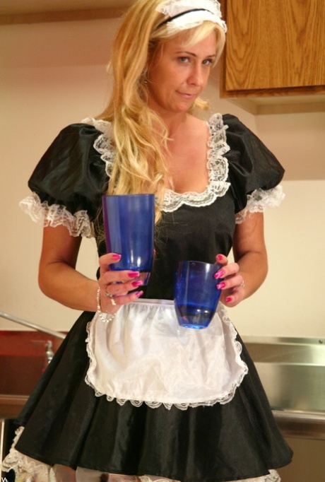 Sexy maid Phyllisha pours some water over her desirable legs while cleaning