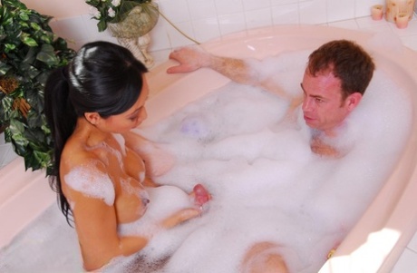 Skinny Asian masseuse Tia Ling gives her client a soapy bathtub handjob