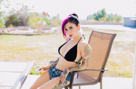 Kinky Joanna Angel wets her sexy inked body with the water hose as she strips