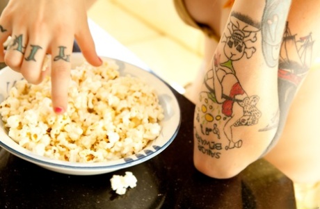 Intense redhead Mabel strips off at the table to get naked with her popcorn - pornpics.de