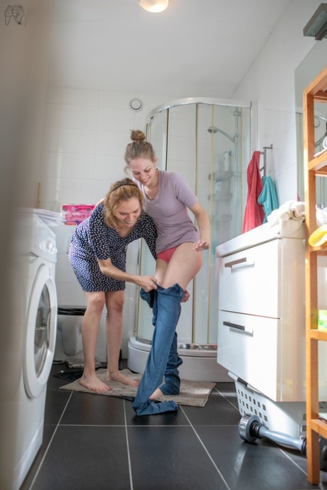 Lesbians Rose K, Layla K show natural tits while dressing in the laundry room