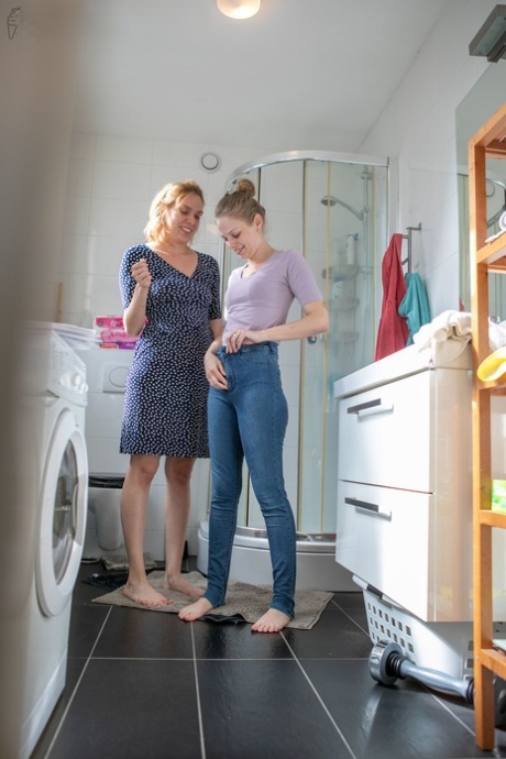 Lesbians Rose K, Layla K show natural tits while dressing in the laundry room