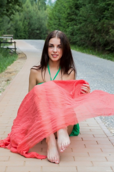 Brunette cutie Evita Lima unveils her twat and adorable ass on the road