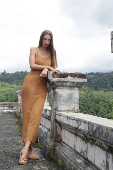 Tall babe Elin unveils her natural tits in a sexy outdoor striptease