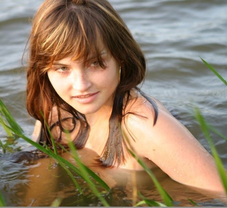 Cute amateur teen with hypnotizing eyes Ann poses naked in the river