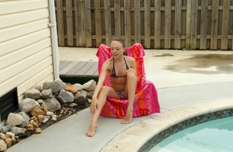 Teenage vixen Aubrey Star getting rid of her bikini and stretching her pussy