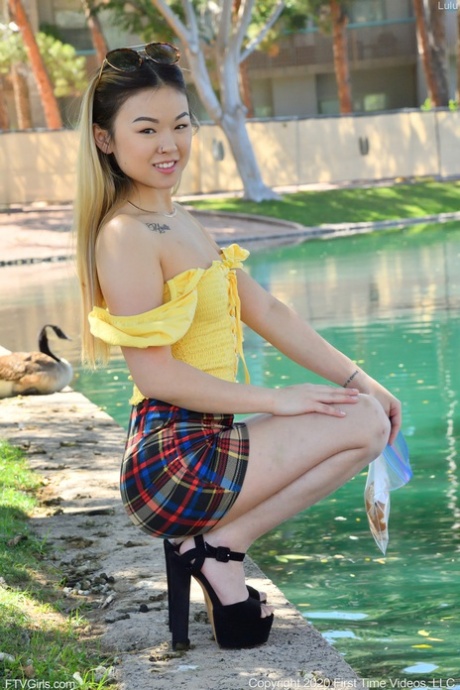 Tiny Asian babe Lulu strips naked in public and masturbates in her heels