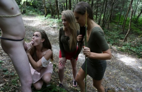Skinny Tina Kay & her clothed pals jack off a tied up man's cock in the woods - pornpics.de
