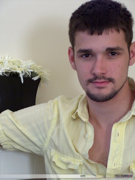 Brunette twink Dominic poses topless and proudly shows his stiff dick