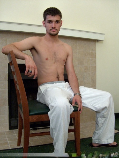 Brunette twink Dominic poses topless and proudly shows his stiff dick