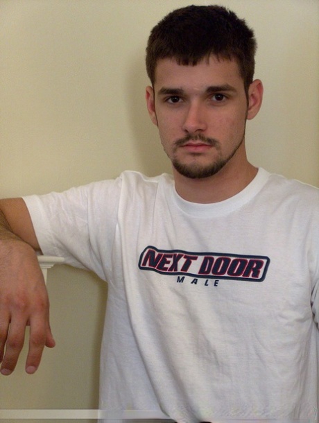 Brunette twink Dominic poses topless and proudly shows his stiff dick