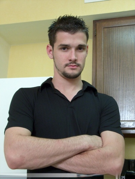 Brunette twink Dominic poses topless and proudly shows his stiff dick