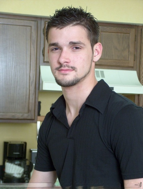 Brunette twink Dominic poses topless and proudly shows his stiff dick