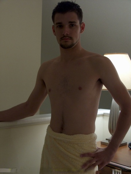 Brunette twink Dominic poses topless and proudly shows his stiff dick