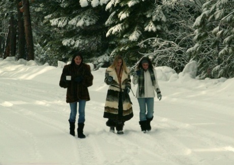 Three big boobed stunners pose braless in their fur coats in the snow