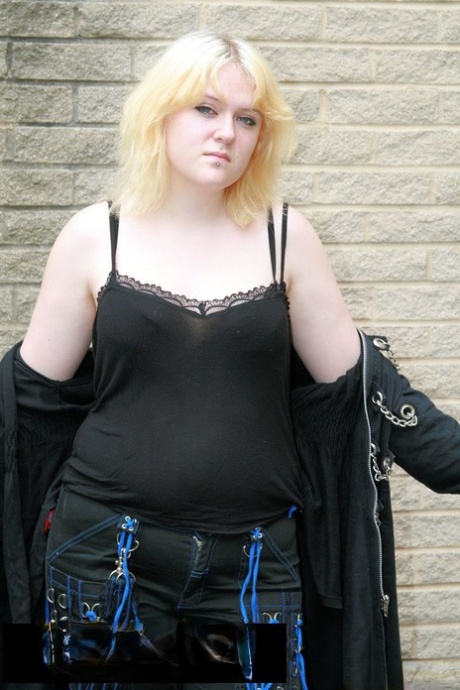 Chubby golden-haired MILF posing in her lovely black outfit in a solo