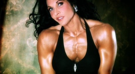 Dark haired bodybuilder Tracy Daniels shows her hot legs in a solo