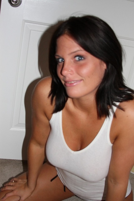 Dark-haired teen Lindsay strips in the bedroom & shows her big tanned curves
