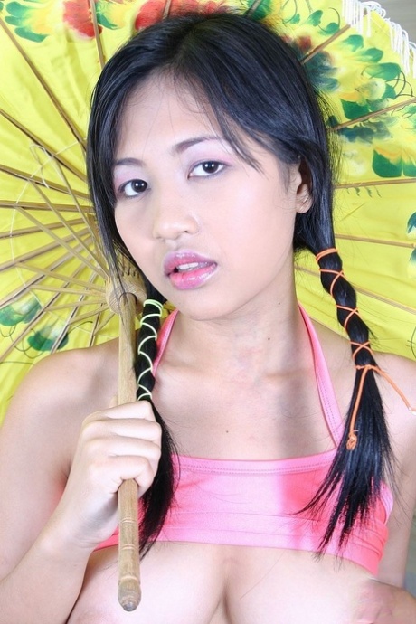 Beautiful Asian doll Pat Mitra reveals her amazing big tits and dildos herself