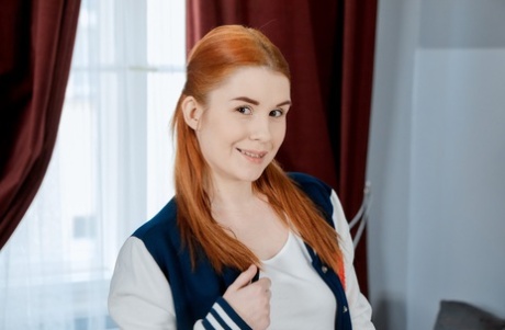 Ginger teen Sweet Angelina shows her fine body and rubs her vagina