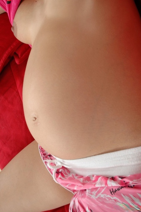 Young pregnant babe Charlotte Pelucci strips nude to show her bulging tummy - pornpics.de