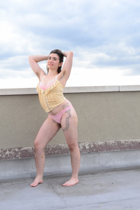 Amateur beauty Kisa Fae strips on the top of a building & shows her hairy body