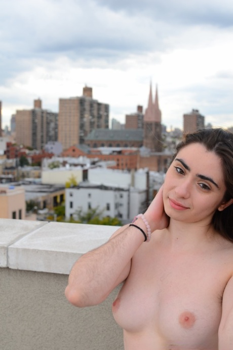 Amateur beauty Kisa Fae strips on the top of a building & shows her hairy body