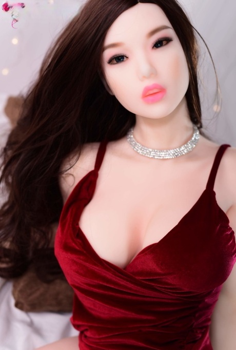 Brunette sex doll Selena posing in her elegant dress and high heels