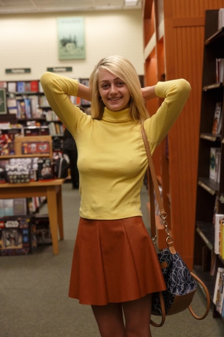 Blonde amateur babe Dahlia Polk exposes her yummy ass & nice tits in a library