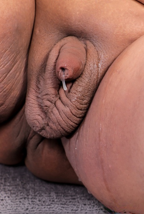 Shemale fatty Joceline stroking her tiny dick and cumming on the sofa