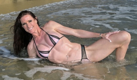 Tight MILF with fake tits Sofie Marie stripping and posing outdoors