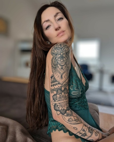 Brunette babe with tattoos Lara Lauren poses in lacy lingerie in the morning
