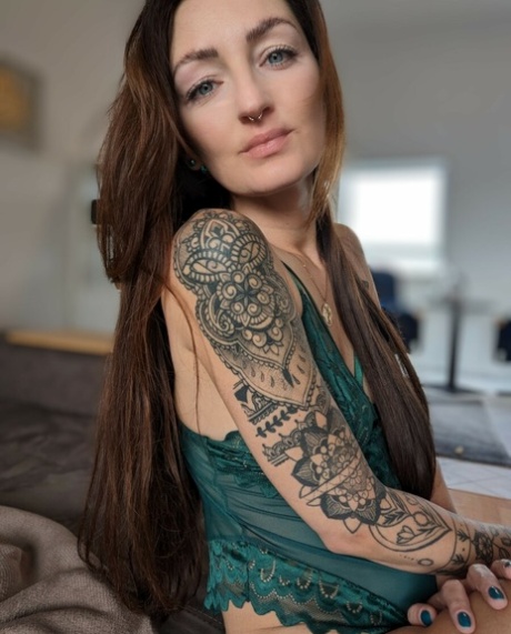 Brunette babe with tattoos Lara Lauren poses in lacy lingerie in the morning