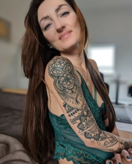 Brunette babe with tattoos Lara Lauren poses in lacy lingerie in the morning
