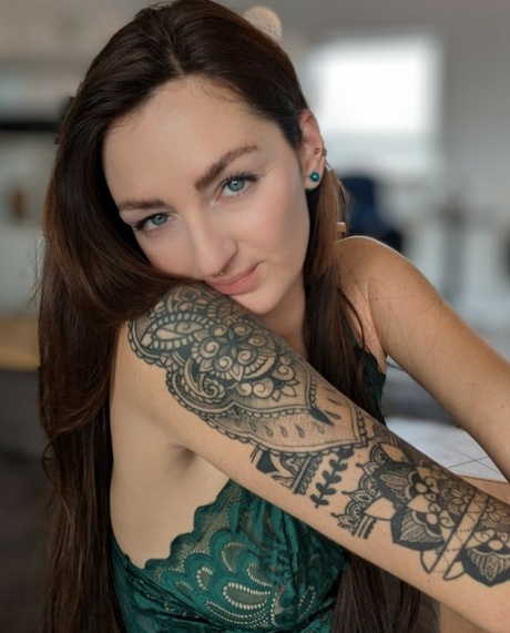 Brunette babe with tattoos Lara Lauren poses in lacy lingerie in the morning