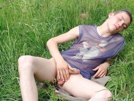 Gay amateur Hubert stripping naked and masturbating in the meadow
