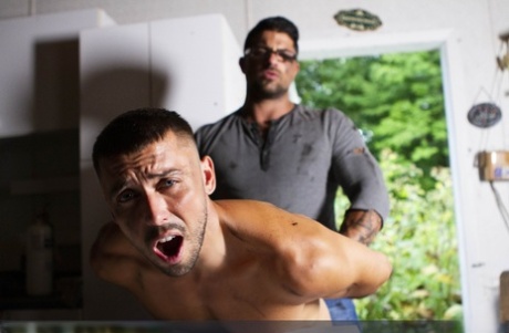 Hung gay Ryan Bones wanks while having wild anal sex with a muscular top