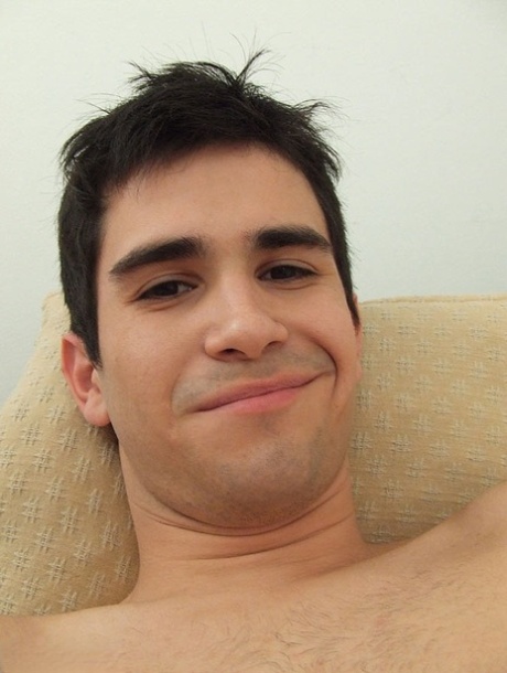 Good-looking twink jerks his big dick until he ejaculates on the couch