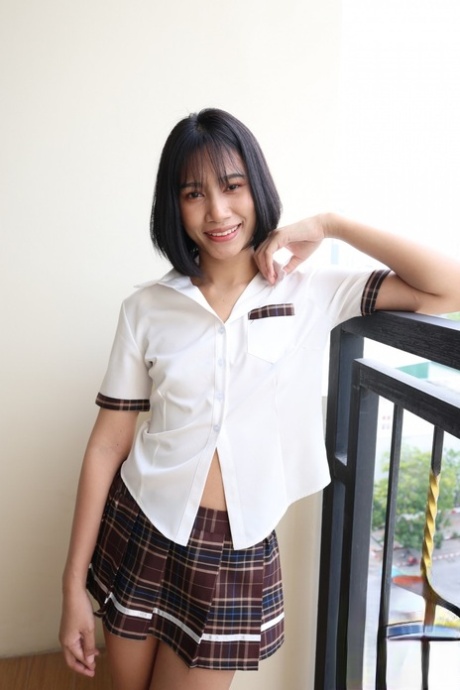 Petite Asian schoolgirl shows her shaved pussy after a sexy striptease