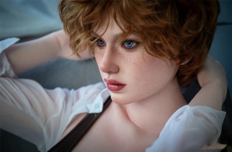 Realistic sex doll with blue eyes shows her red nipples and sweet ass