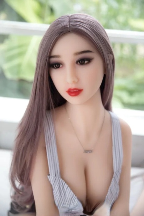 Pretty sex doll shows her puffy pussy and her beautiful big boobs