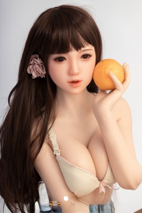 Small sex doll Leonora posing in her white bra and jean shorts in a solo