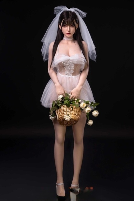 Pretty sex doll shows her petite body in a sexy wedding dress & while naked