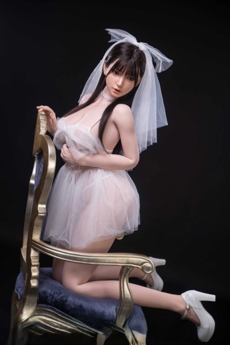 Pretty sex doll shows her petite body in a sexy wedding dress & while naked